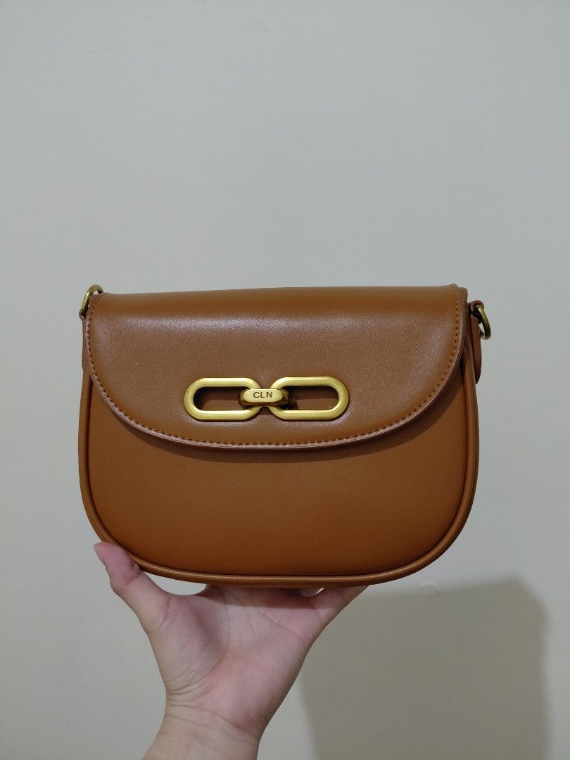 CLN Brown Shoulder Bag with Gold Clasp (Category: Shoulder Bags) located in Imus. Submitted by Kayce (Listing ID 1442613416, Image 1). Description: - Brand: CLN - Color: Brown - Style: Shoulder bag - Closure: Gold chain-like clasp - Includes: Dust bag, original CLN shopping bag - Condition: Minimal signs of wear, clean interior - Versatile: Suitable for everyday or special occasions.