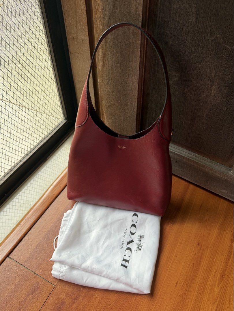 Coach Brooklyn 28 Burgundy (Category: Luxury Bags & Wallets) located in Las Pinas. Submitted by blt.declutter (Listing ID 1441237657, Image 1). Description: - 101% authentic! u can do unli-checks - Comes with original dust bag - minimal signa of use + i lost the coach charm lang na nakahang supposedly on the side :") rfs: eyeing a different coach bag.