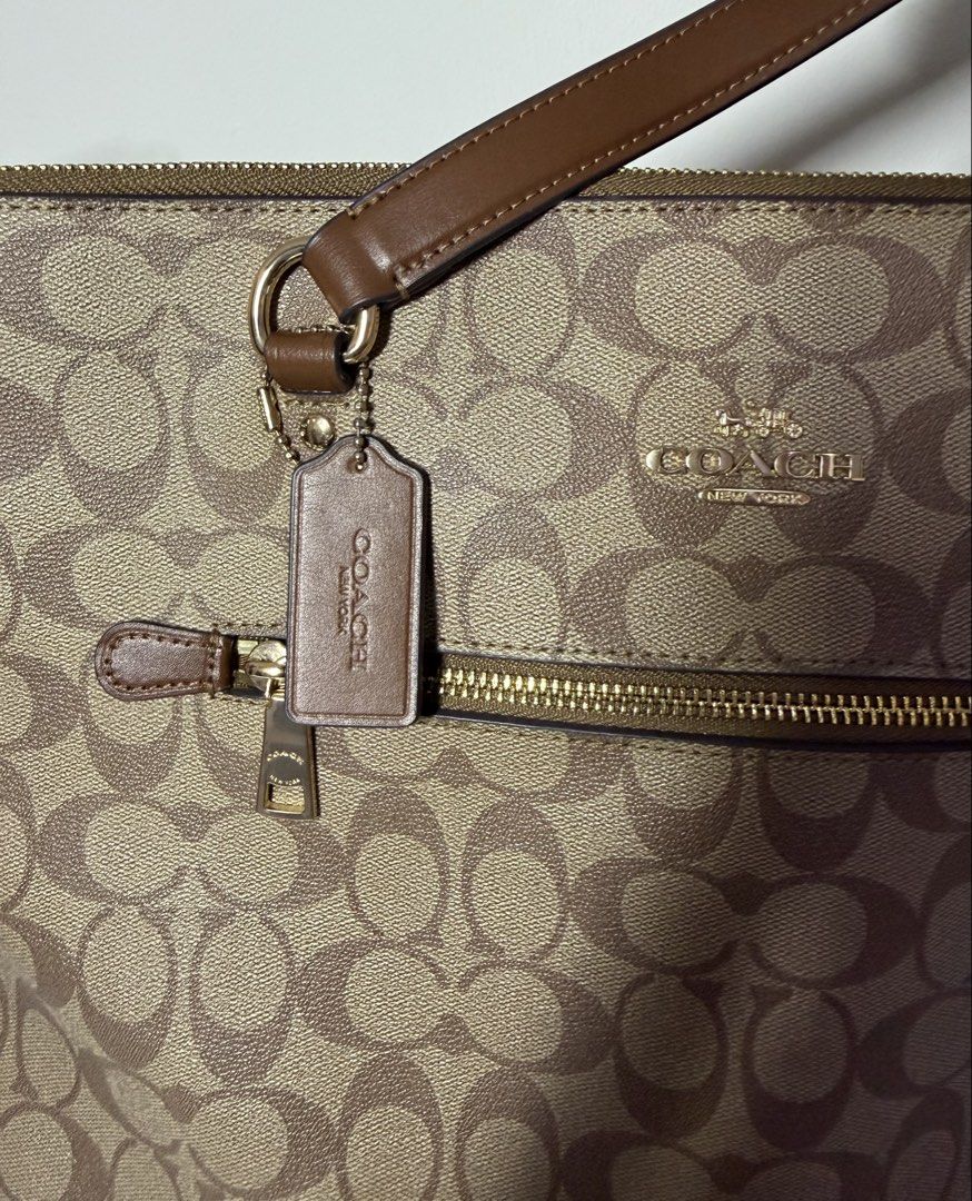 Coach Gallery Khaki Tote Bag (Category: Luxury Bags & Wallets) located in Manila. Submitted by importgoodiesph (Listing ID 1442587132, Image 2). Description: Coach Tote Bag - in excellent condition - color: khaki - material: signature coated canvas - 3 inner pockets, 1 outside compartment - zip-top closure, fabric lining - handles: 10 1/4in drop - dimensions: 12 3/4in (L) × 10 1/2in (H) × 5 1/2in (W) - inclusions: bag and care instruction card - 