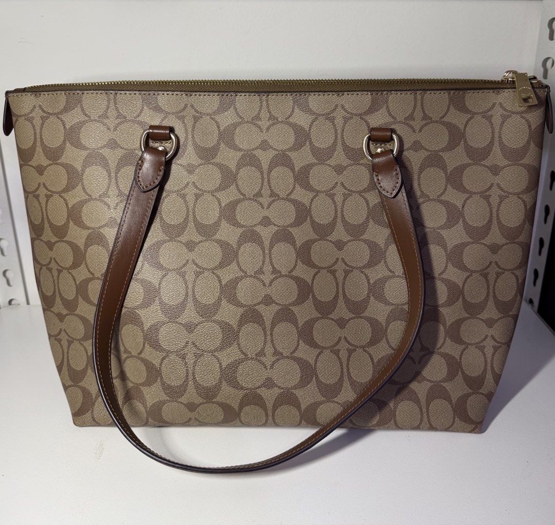 Coach Gallery Khaki Tote Bag (Category: Luxury Bags & Wallets) located in Manila. Submitted by importgoodiesph (Listing ID 1442587132, Image 3). Description: Coach Tote Bag - in excellent condition - color: khaki - material: signature coated canvas - 3 inner pockets, 1 outside compartment - zip-top closure, fabric lining - handles: 10 1/4in drop - dimensions: 12 3/4in (L) × 10 1/2in (H) × 5 1/2in (W) - inclusions: bag and care instruction card - 