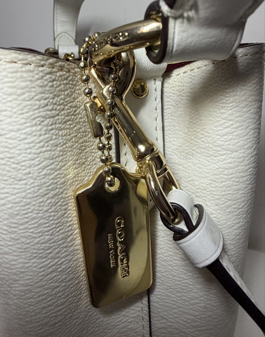 Coach Mollie Bucket Bag (Category: Luxury Bags & Wallets) located in Manila. Submitted by importgoodiesph (Listing ID 1442585454, Image 3). Description: Coach Mollie Bucket Bag - like new condition - color: chalk - material: signature coated canvas and smooth leather - dimensions: - L: 4.0in x H: 8.0in x W: 8.5 in - handle: 6.75in drop - detachable strap: 22 in drop - gold tone hardwares and tag - snap closure center with zip compartment - inclus