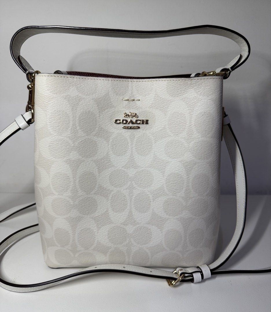 Coach Mollie Bucket Bag (Category: Luxury Bags & Wallets) located in Manila. Submitted by importgoodiesph (Listing ID 1442585454, Image 1). Description: Coach Mollie Bucket Bag - like new condition - color: chalk - material: signature coated canvas and smooth leather - dimensions: - L: 4.0in x H: 8.0in x W: 8.5 in - handle: 6.75in drop - detachable strap: 22 in drop - gold tone hardwares and tag - snap closure center with zip compartment - inclus