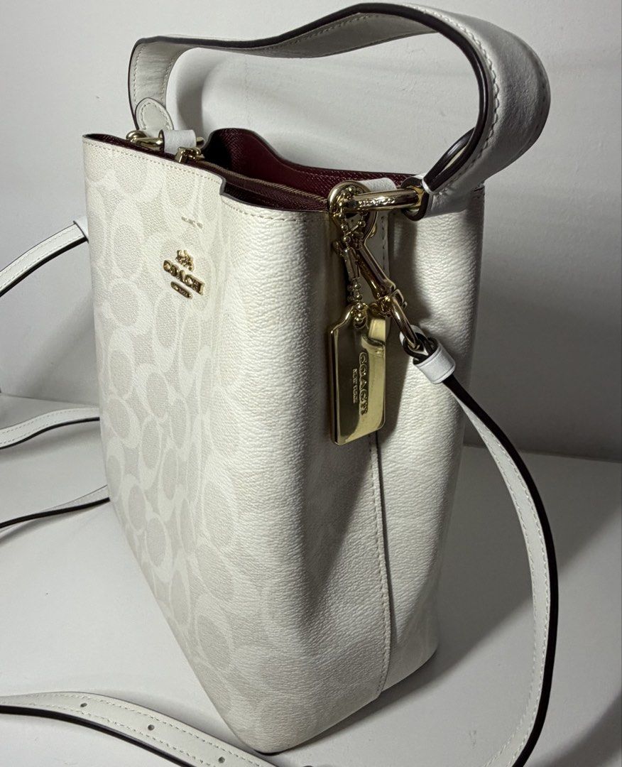 Coach Mollie Bucket Bag (Category: Luxury Bags & Wallets) located in Manila. Submitted by importgoodiesph (Listing ID 1442585454, Image 2). Description: Coach Mollie Bucket Bag - like new condition - color: chalk - material: signature coated canvas and smooth leather - dimensions: - L: 4.0in x H: 8.0in x W: 8.5 in - handle: 6.75in drop - detachable strap: 22 in drop - gold tone hardwares and tag - snap closure center with zip compartment - inclus