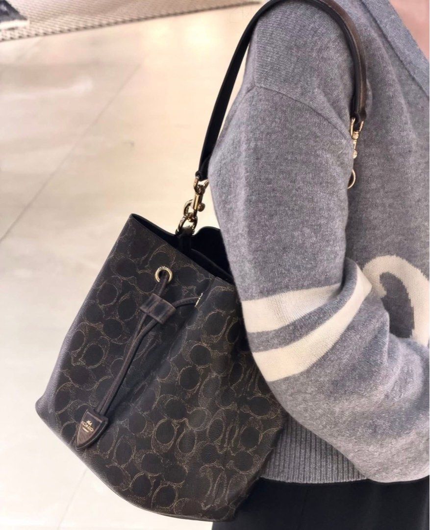 Coach Signature Bucket Bag (Category: Shoulder Bags) located in Caloocan City. Submitted by brandeditemsph (Listing ID 1442680417, Image 1). Description: - Coach bucket bag - Signature print - Drawstring closure - Leather trim and strap - Detachable charm included - Ideal for everyday use - Spacious interior.
