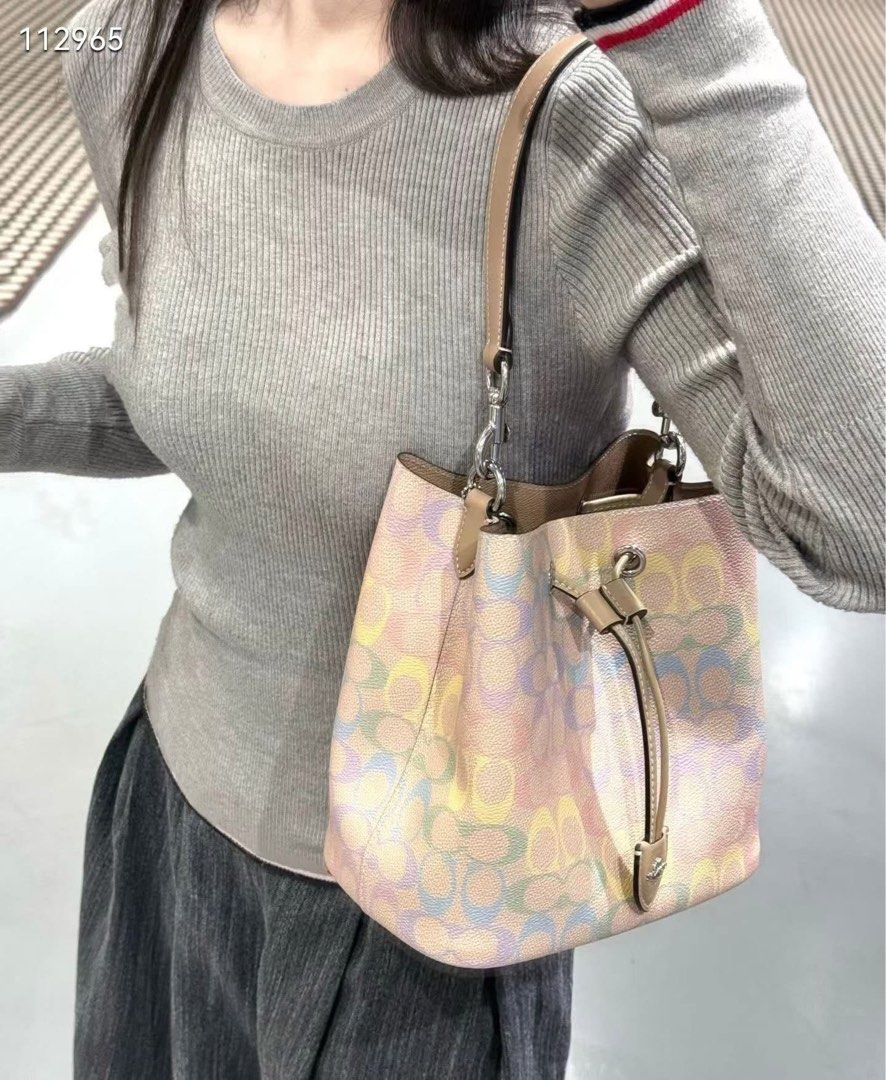 Coach Signature Bucket Bag (Category: Shoulder Bags) located in Caloocan City. Submitted by brandeditemsph (Listing ID 1442680417, Image 3). Description: - Coach bucket bag - Signature print - Drawstring closure - Leather trim and strap - Detachable charm included - Ideal for everyday use - Spacious interior.