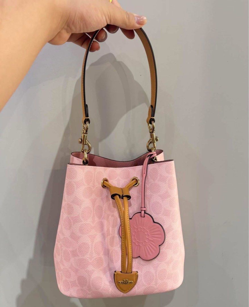 Coach Signature Bucket Bag (Category: Shoulder Bags) located in Caloocan City. Submitted by brandeditemsph (Listing ID 1442680417, Image 2). Description: - Coach bucket bag - Signature print - Drawstring closure - Leather trim and strap - Detachable charm included - Ideal for everyday use - Spacious interior.