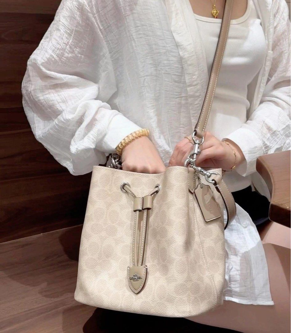 Coach Signature Bucket Bag (Category: Shoulder Bags) located in Caloocan City. Submitted by brandeditemsph (Listing ID 1442680518, Image 2). Description: - Classic Coach bucket bag - Signature C print - Drawstring closure - Adjustable strap - Leather trim and details - Available in beige and off-white - Ideal for everyday use - Spacious interior.