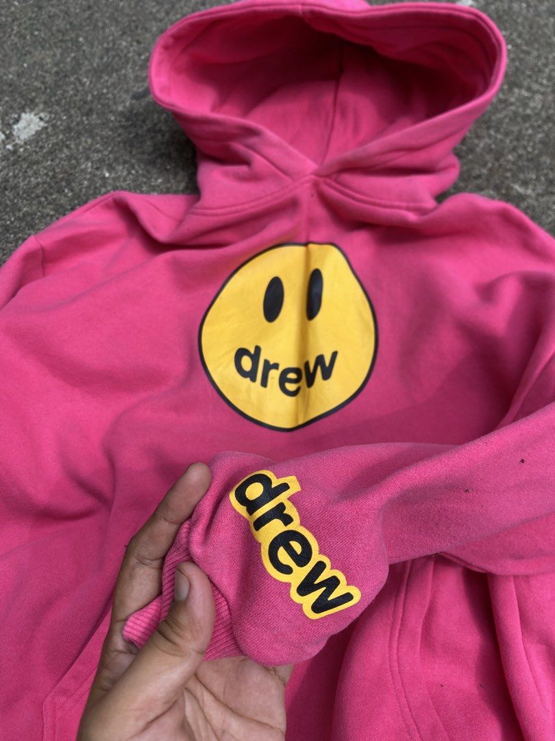 Drew House Pink hoodie (Category: Hoodies) located in Batangas. Submitted by arries_thirft (Listing ID 1442600233, Image 2). Description: - Authentic Pink Drew House Hoodie - Iconic smiley face logo on front - Small Drew logo on sleeve cuff - Size: Large (L) - Comfortable and stylish for everyday wear - Perfect for casual outfits 1500 plus sf Batangas location .