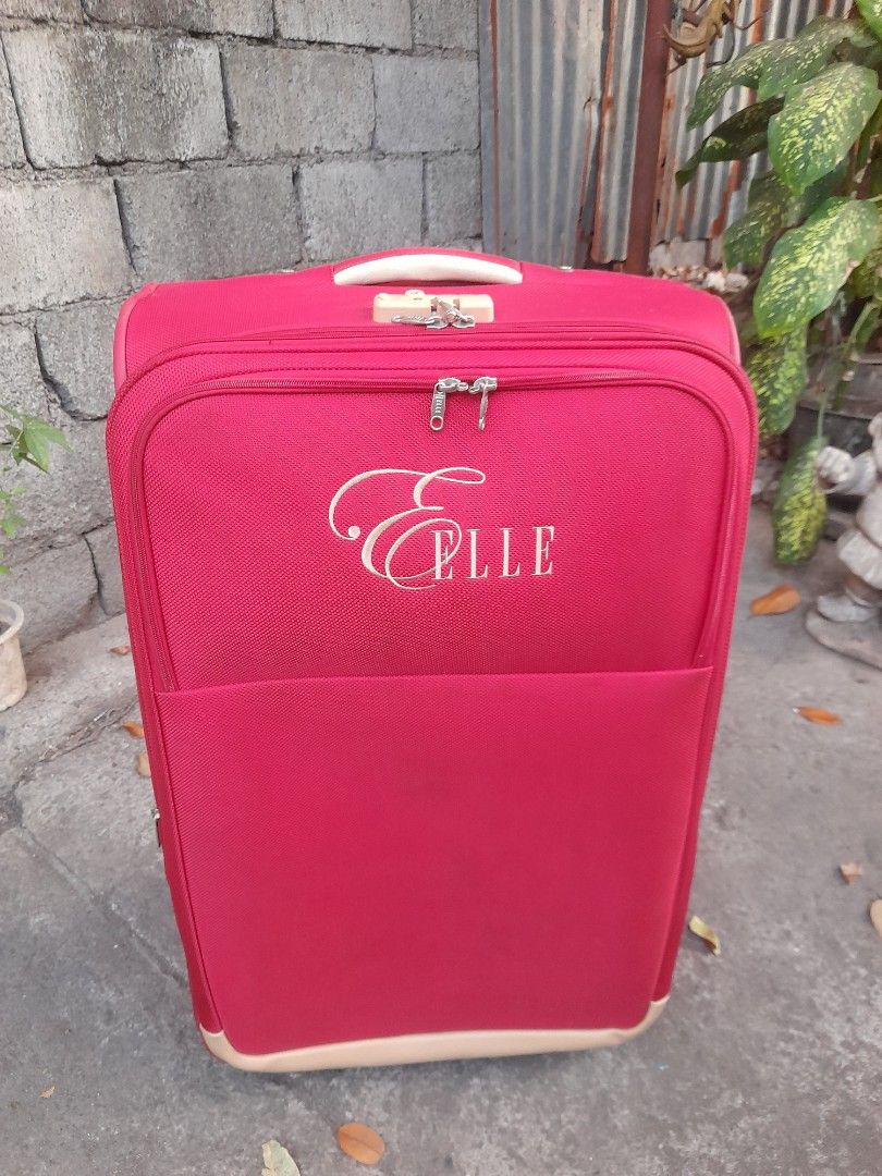 Elle Red Rolling Suitcase Luggage with TSA Lock (Category: Luggage) located in Valenzuela. Submitted by newbear.425b6e (Listing ID 1442608296, Image 2). Description: - Vibrant red Elle suitcase, perfect for travel. - Features a built-in TSA lock for security. - Smooth-rolling wheels for easy maneuverability. - Telescopic handle extends for comfortable handling. - Interior straps keep your belongings securely in place. - Spacious interior offers p