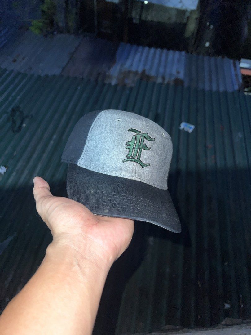 Grey and Black Baseball Cap with 'F' Logo (Category: Caps & Hats) located in Manila. Submitted by jesus.jae (Listing ID 1442701769, Image 1). Description: - Grey baseball cap - Black brim and bill - Green embroidered 'F' logo on front - Adjustable strap for a good fit - Perfect for casual wear or sports.