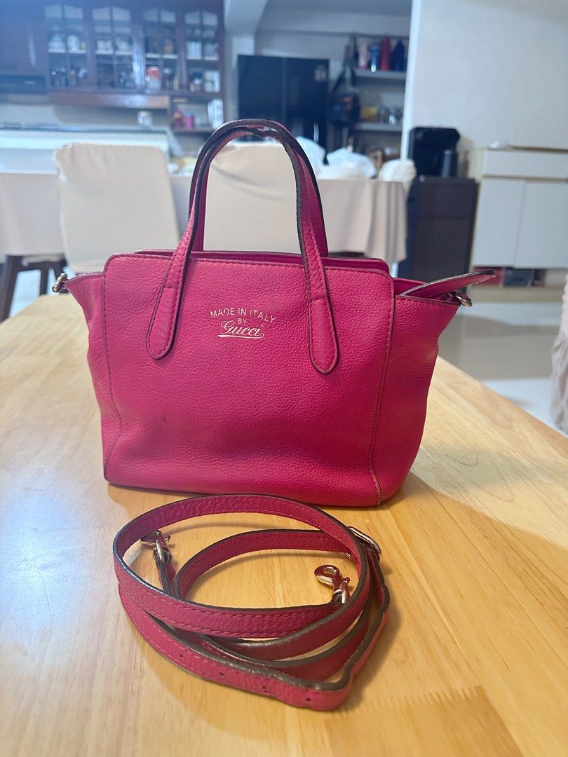 Gucci Pink Leather Top Handle Bag with Strap (Category: Luxury Bags & Wallets) located in Consolacion. Submitted by marjmier (Listing ID 1442620828, Image 2). Description: - Authentic Gucci handbag in vibrant pink - Made in Italy - Features top handles - Includes a detachable shoulder strap - Interior zippered pocket and slip pockets - Minor wear on handles and strap edges -Missing tag.
