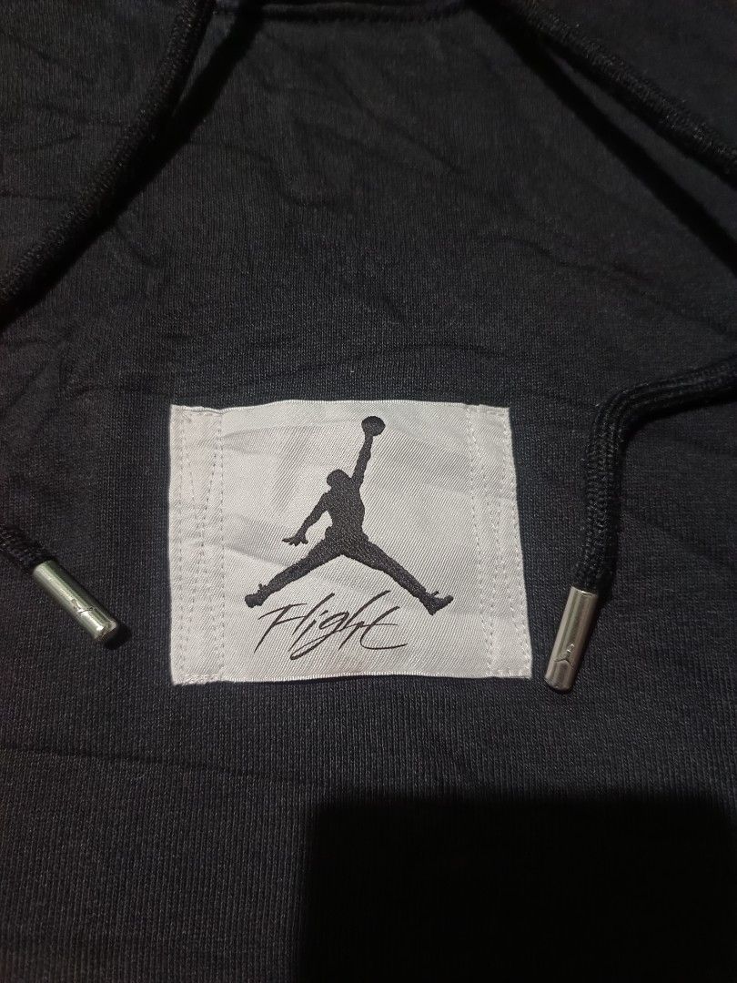 Jordan Flight Black Hoodie (Category: Coats, Jackets and Outerwear) located in Barotac Nuevo. Submitted by gray101 (Listing ID 1442676692, Image 3). Description: - Black Jordan hoodie - Features iconic Jumpman Flight logo on chest - Front kangaroo pocket - Adjustable drawstrings for hood - Made from 100% comfortable cotton - Ideal for everyday casual wear - Tag indicates 'Made in China'.