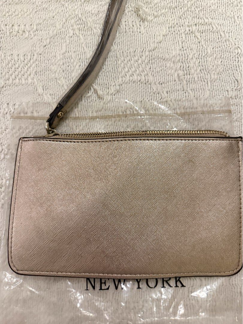 Kate Spade New York Wristlet Pouch (Category: Purses & Pouches) located in Paranaque City. Submitted by izdeclutters (Listing ID 1442656423, Image 2). Description: - Brand: Kate Spade New York - Color: Metallic Champagne - Closure: Zip - Features: Detachable wrist strap .