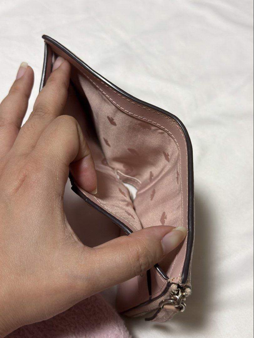 Kate Spade Pink Leather Bifold Wallet (Category: Wallets & Card holders) located in Muntinlupa City. Submitted by kiarraaa (Listing ID 1442545615, Image 3). Description: - Brand: Kate Spade - Color: Pink - Material: Leather - Style: Bifold Wallet - Features: Zip around coin pocket, interior card slots, snap closure for bills - Exterior: Small logo on the front - Approximate Dimensions (closed): 4.5 inches wide x 3.5 inches tall .