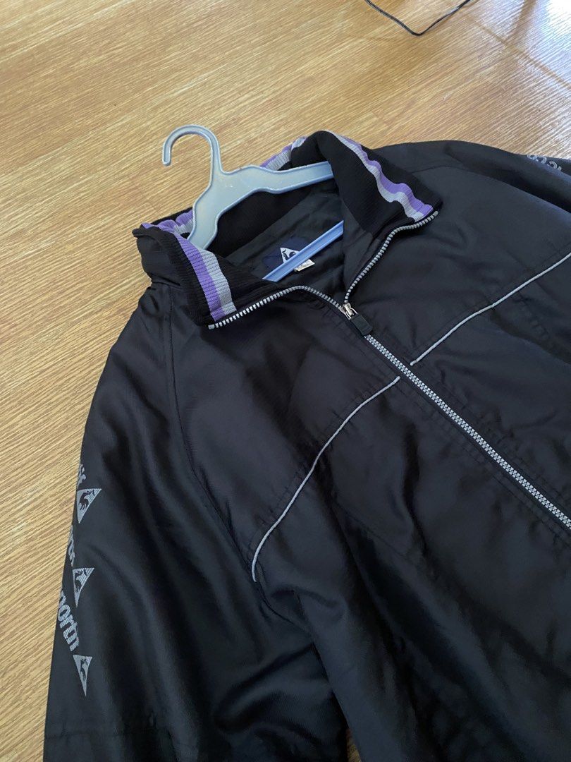 Le Coq Sportif Black Track Jacket (Category: Coats, Jackets and Outerwear) located in Manila. Submitted by deliriously (Listing ID 1442581066, Image 2). Description: - Black Le Coq Sportif track jacket - Features purple and grey striped collar and cuffs - Le Coq Sportif logo on sleeve and back - Zip-up front closure - May pocketable hood - 26.5 Length 25 Width Boxy type.