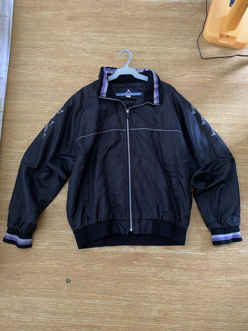 Le Coq Sportif Black Track Jacket (Category: Coats, Jackets and Outerwear) located in Manila. Submitted by deliriously (Listing ID 1442581066, Image 1). Description: - Black Le Coq Sportif track jacket - Features purple and grey striped collar and cuffs - Le Coq Sportif logo on sleeve and back - Zip-up front closure - May pocketable hood - 26.5 Length 25 Width Boxy type.