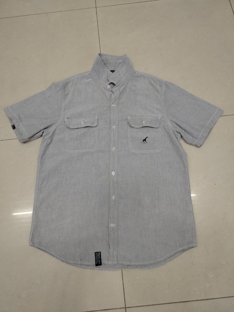 Light Blue Leaf Print Short Sleeve Button Up Shirt (Category: Shirts) located in San Pablo. Submitted by nhatzstuffz (Listing ID 1442685268, Image 3). Description: Cool short sleeve shirt with a tropical leaf print. Light blue and white/grey colors. Button-up front with a collar. Great for casual wear or a beach vibe. Comfortable fabric. Good for sunny days..