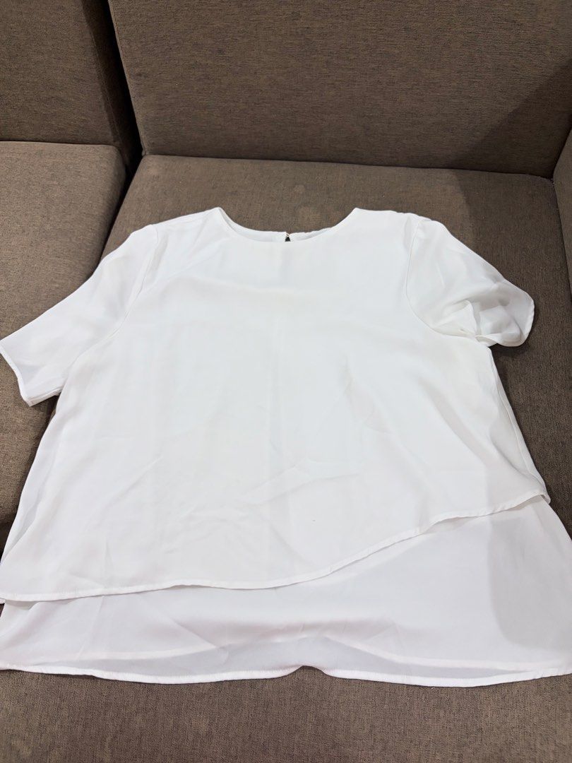 Mango Basics White Layered Chiffon Blouse Size S (Category: Blouses) located in Santa Cruz, Pampanga. Submitted by emgihem (Listing ID 1442620578, Image 1). Description: - White layered chiffon blouse from Mango Basics - Short sleeves - Flowy, asymmetrical hem - Button closure at the back neck - Lightweight and airy material - Versatile for dressing up or down.