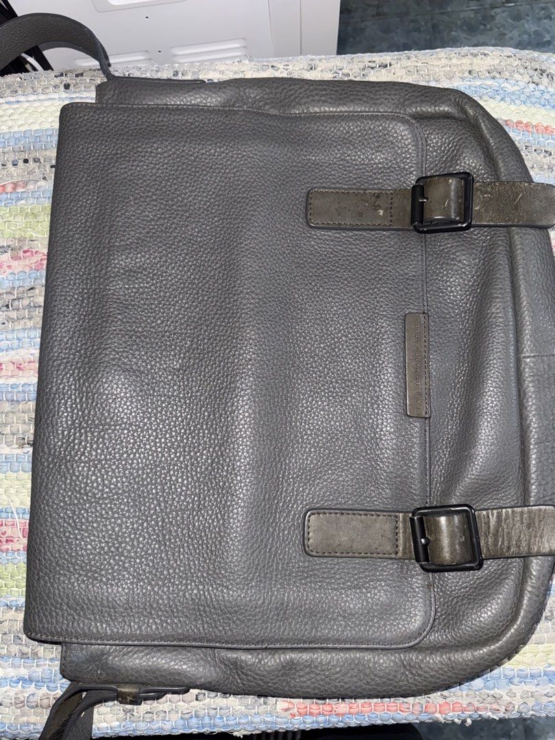 Marc by Marc Jacobs Grey Leather Messenger Bag (Category: Luxury Bags & Wallets) located in Makati City. Submitted by vinsanity41546 (Listing ID 1442605114, Image 1). Description: - Brand: Marc by Marc Jacobs - Material: Grey pebbled leather - Closure: Buckle closures on front flap - Strap: Adjustable shoulder strap - Interior: Zip pocket - Condition: Minor signs of wear on leather and strap - Ideal for: Everyday use.