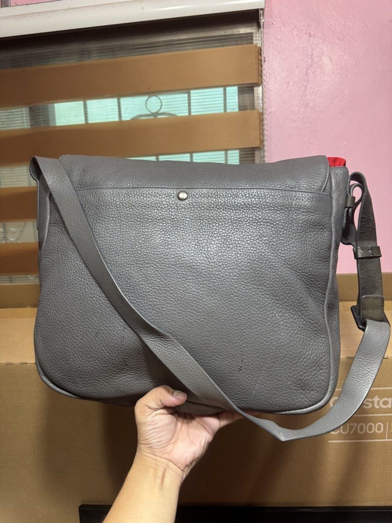Marc by Marc Jacobs Grey Leather Messenger Bag (Category: Luxury Bags & Wallets) located in Makati City. Submitted by vinsanity41546 (Listing ID 1442605114, Image 3). Description: - Brand: Marc by Marc Jacobs - Material: Grey pebbled leather - Closure: Buckle closures on front flap - Strap: Adjustable shoulder strap - Interior: Zip pocket - Condition: Minor signs of wear on leather and strap - Ideal for: Everyday use.