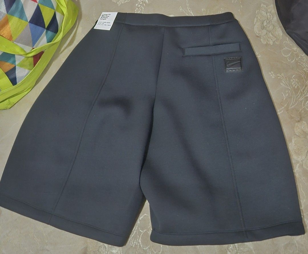 Nike Black Wide Leg Shorts (Category: Shorts) located in Rodriguez. Submitted by Branded100 (Listing ID 1442699363, Image 2). Description: - Black Nike shorts - Wide leg design - Zipper fly with button closure - Back pocket with Nike logo detail - Made from thick, neoprene-like fabric - Perfect for casual wear or light sports.