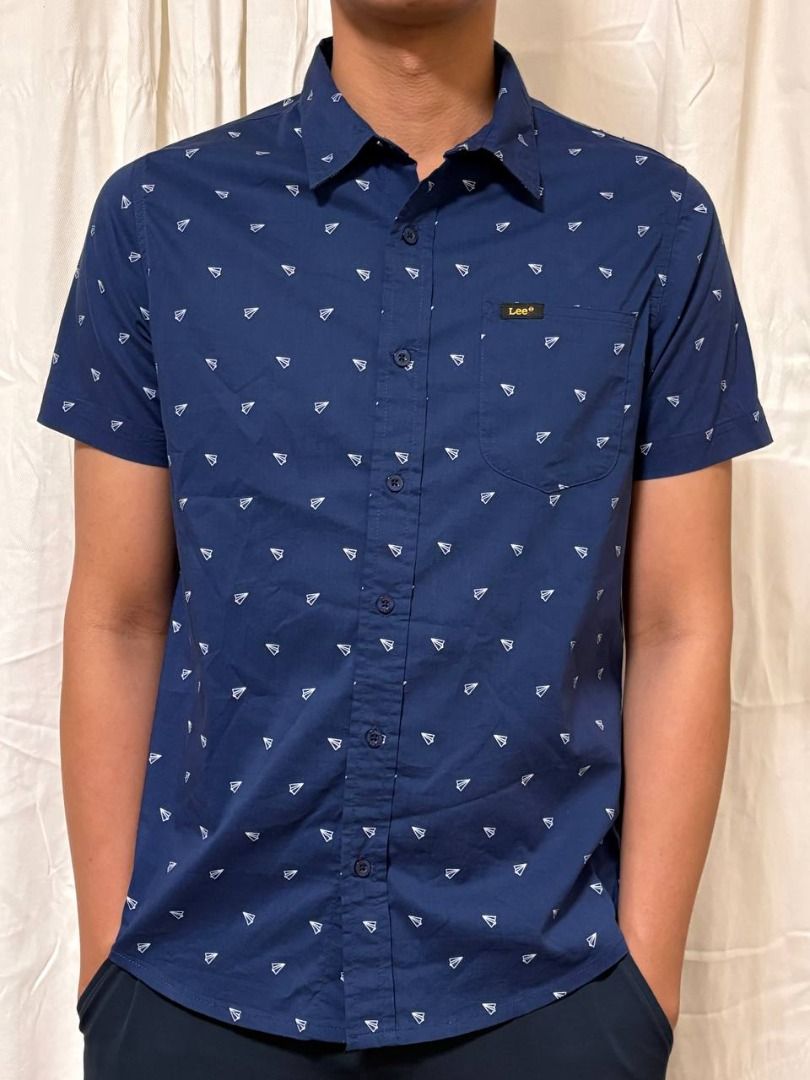 Original Lee Printed Short Sleeve Button Up in Navy Blue (Category: Tshirts & Polo Shirts ) located in Manila. Submitted by CaraSui (Listing ID 1442660953, Image 1). Description: Original Lee Short Sleeve Button Up Shirt Printed Fabric: Poplin Color: Navy Blue Design: Printed Collar: Collared Neckline Pocket: One Pocket Size: Small Chest width: 38 inches (est) Length: 24.5 inches (est) Base size reference on description.