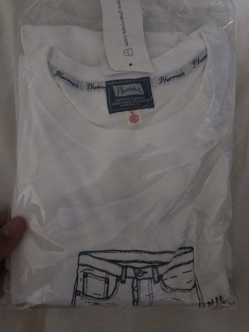 Pherrows & Co. Tokyo Japan White T-shirt (Category: Tshirts & Polo Shirts ) located in Paranaque City. Submitted by armoredclavio (Listing ID 1442675135, Image 1). Description: - Brand: Pherrows & Co. - Color: White - Design: Graphic print of jeans (front and back) - Origin: Made in Japan - Condition: Brand new, still in original packaging.