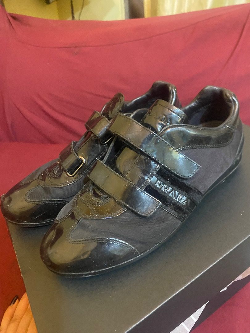 Prada Black Patent Leather Velcro Sneakers (Category: Sneakers) located in Quezon City. Submitted by learose26638332 (Listing ID 1442666491, Image 3). Description: - Authentic Prada sneakers in black. - Unique mix of patent leather and fabric. - Secure and stylish triple velcro strap closure. - Comes with original dust bag and box. - Ideal for elevating your casual outfits. Size 33 .