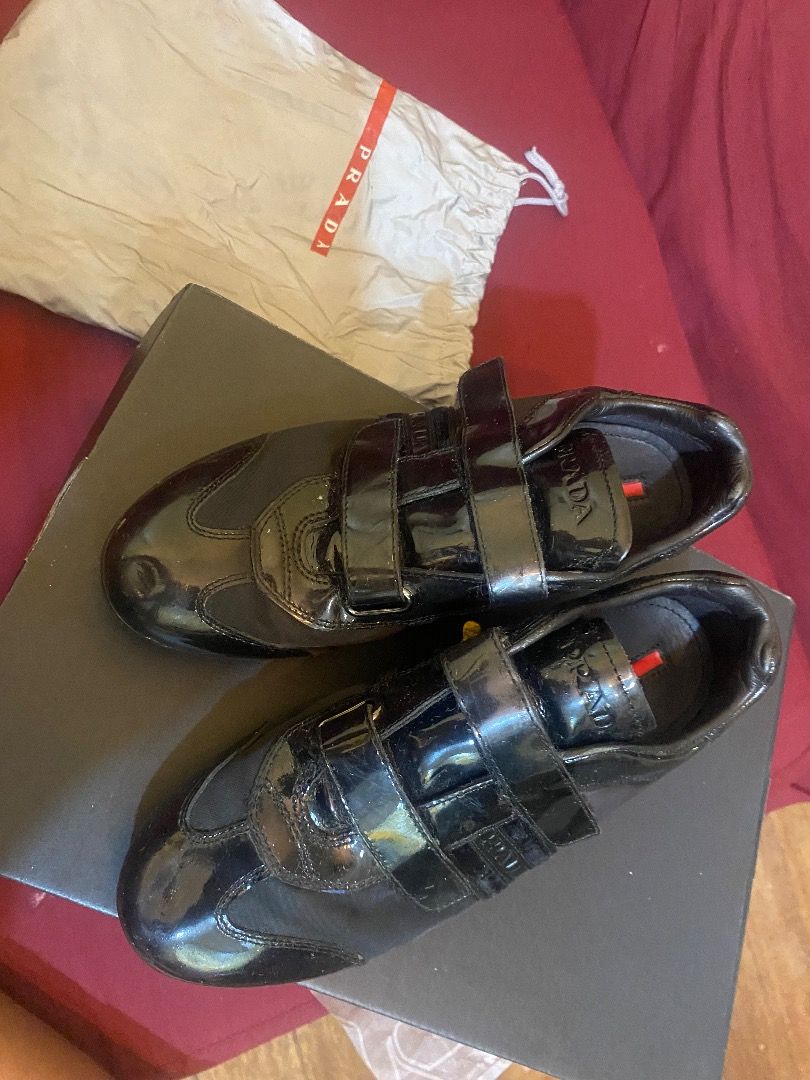Prada Black Patent Leather Velcro Sneakers (Category: Sneakers) located in Quezon City. Submitted by learose26638332 (Listing ID 1442666491, Image 1). Description: - Authentic Prada sneakers in black. - Unique mix of patent leather and fabric. - Secure and stylish triple velcro strap closure. - Comes with original dust bag and box. - Ideal for elevating your casual outfits. Size 33 .