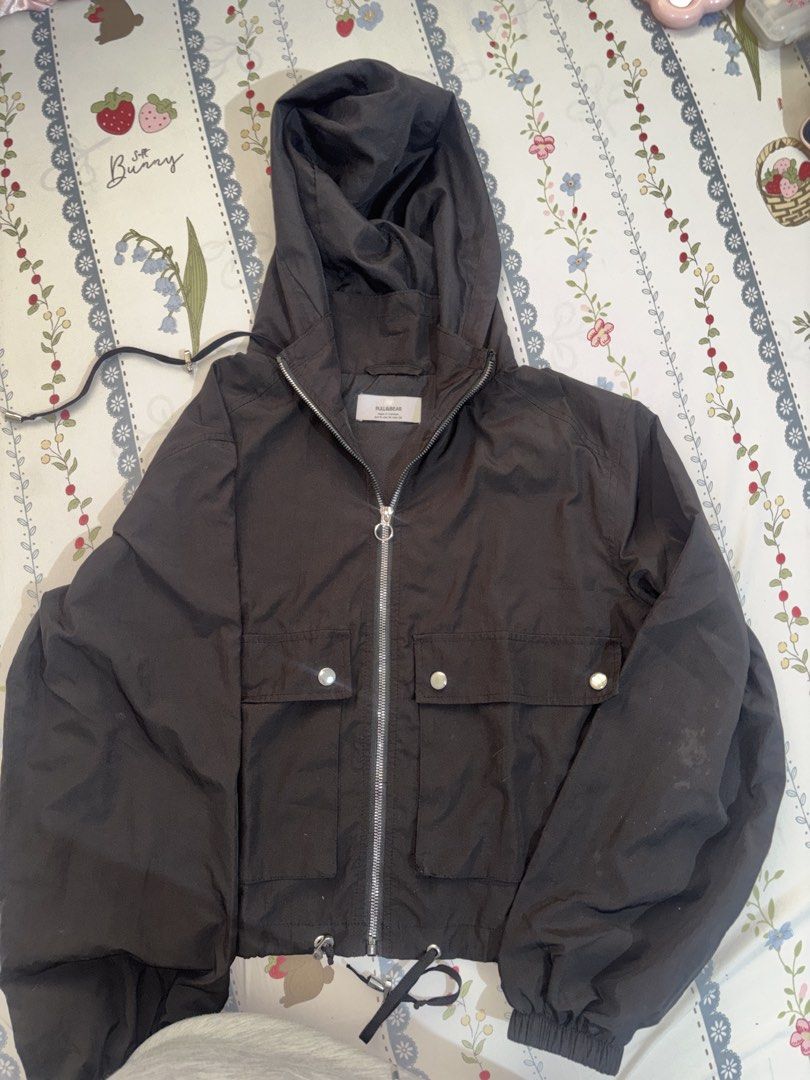 Bershka Black Hooded Zip-Up Jacket (Category: Coats, Jackets and Outerwear) located in Manila. Submitted by bellsellsss (Listing ID 1442546748, Image 1). Description: - Black hooded jacket from Pull & Bear - Zip-up front - Two buttoned pockets - Drawstring hem - Estimated size M - Ideal for layering or cooler weather.