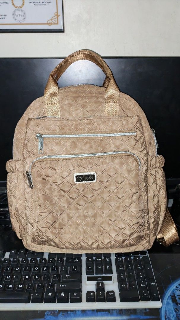 Quilted Brown Backpack with Multiple Pockets (Category: Backpacks) located in San Mateo. Submitted by gorgeousglam (Listing ID 1442575720, Image 3). Description: slightly used madami pockets.