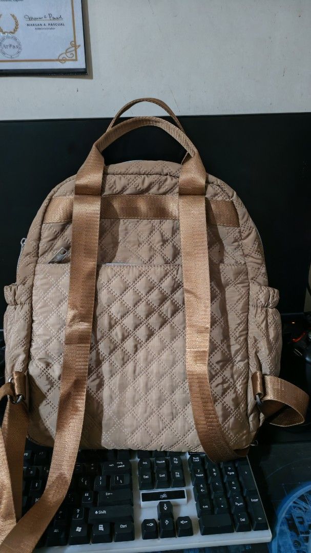 Quilted Brown Backpack with Multiple Pockets (Category: Backpacks) located in San Mateo. Submitted by gorgeousglam (Listing ID 1442575720, Image 2). Description: slightly used madami pockets.