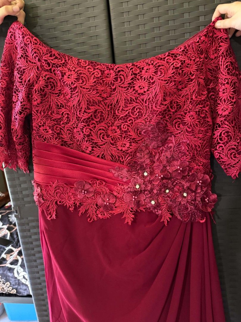 Red Evening Gown (Category: Evening dresses & gowns) located in Bulacan. Submitted by Domozz (Listing ID 1442583101, Image 3). Description: - Beautiful red formal gown - Intricate lace detailing on bodice and sleeves - Elegant off-shoulder design with floral embellishments - Flattering floor-length skirt - Ideal for weddings, galas, and special occasions - Measurements available upon request - Message for details.