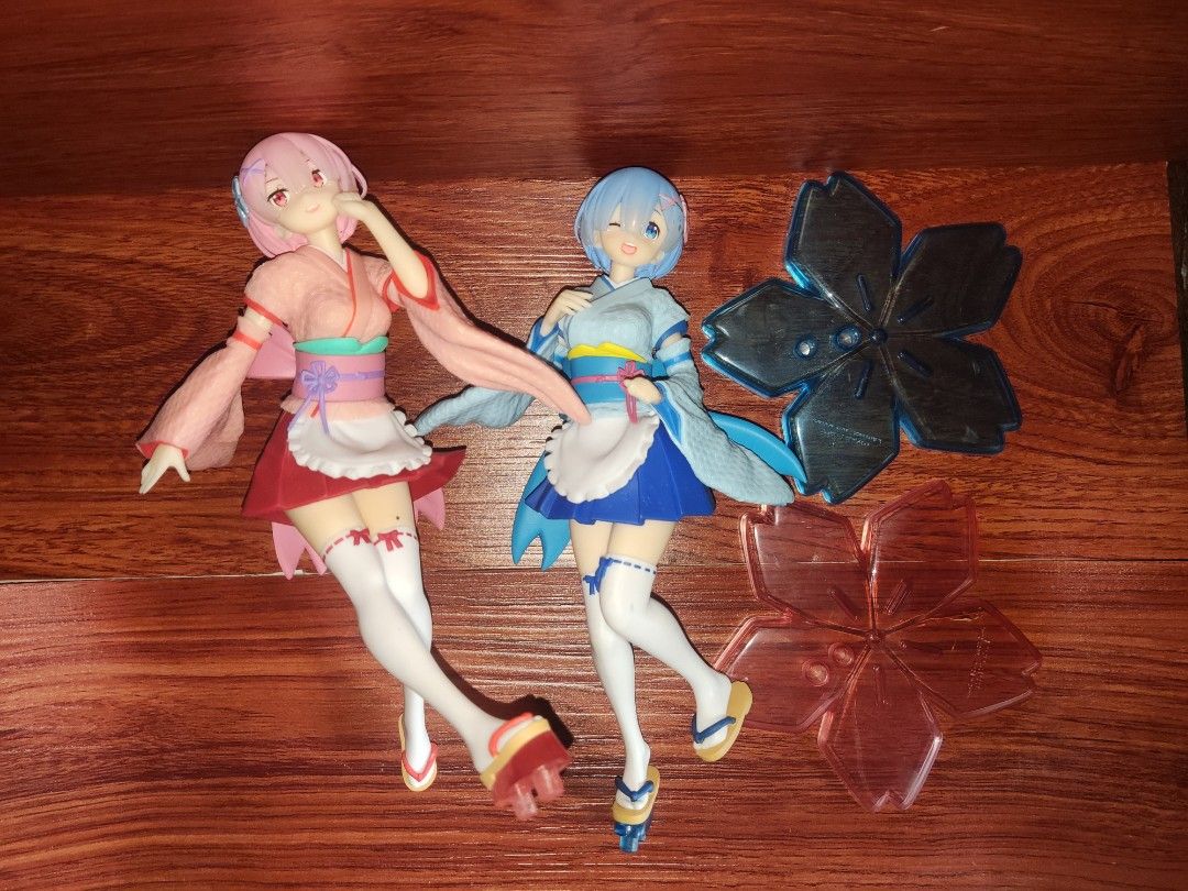 Re:Zero Ram & Rem Figures with Cherry Blossom Stands (Category: Figurines & Statues) located in General Mariano Alvarez. Submitted by zen_006 (Listing ID 1442602226, Image 1). Description: - Wafuu Maid Set of Ram and Rem figures from Re:Zero - Includes special cherry blossom display stands - Ideal for fans of the Re:Zero series - Sold as a complete set - Please expect minor scratch or paint chip -Loose figure only.