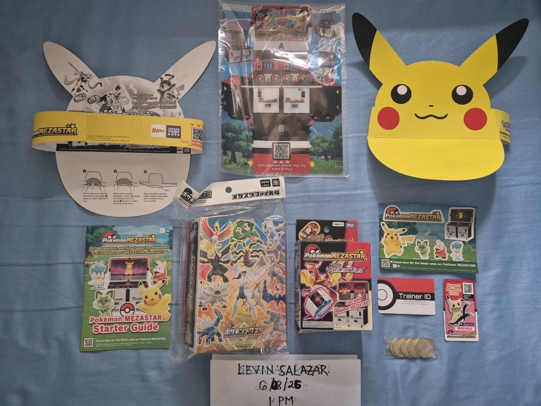 (SEALED) POKEMON MEZASTAR COLLECTION (Category: Raw Singles) located in Guiguinto. Submitted by Levinthings (Listing ID 1442594806, Image 1). Description: Quitting SALE: (Take ALL) Pokemon Mezastar Collection >Inclusions: - (2) Pikachu Event Pre-launch Hat - (COMPLETE) Event Pre-launch Starter Kit - (SEALED) File Album Version 4 - (SEALED) Charizard Dynamax Band - (Unused) Trainer ID card - Mimikyu Support card - (5) Tokens - (SEALED) Greninja Ev