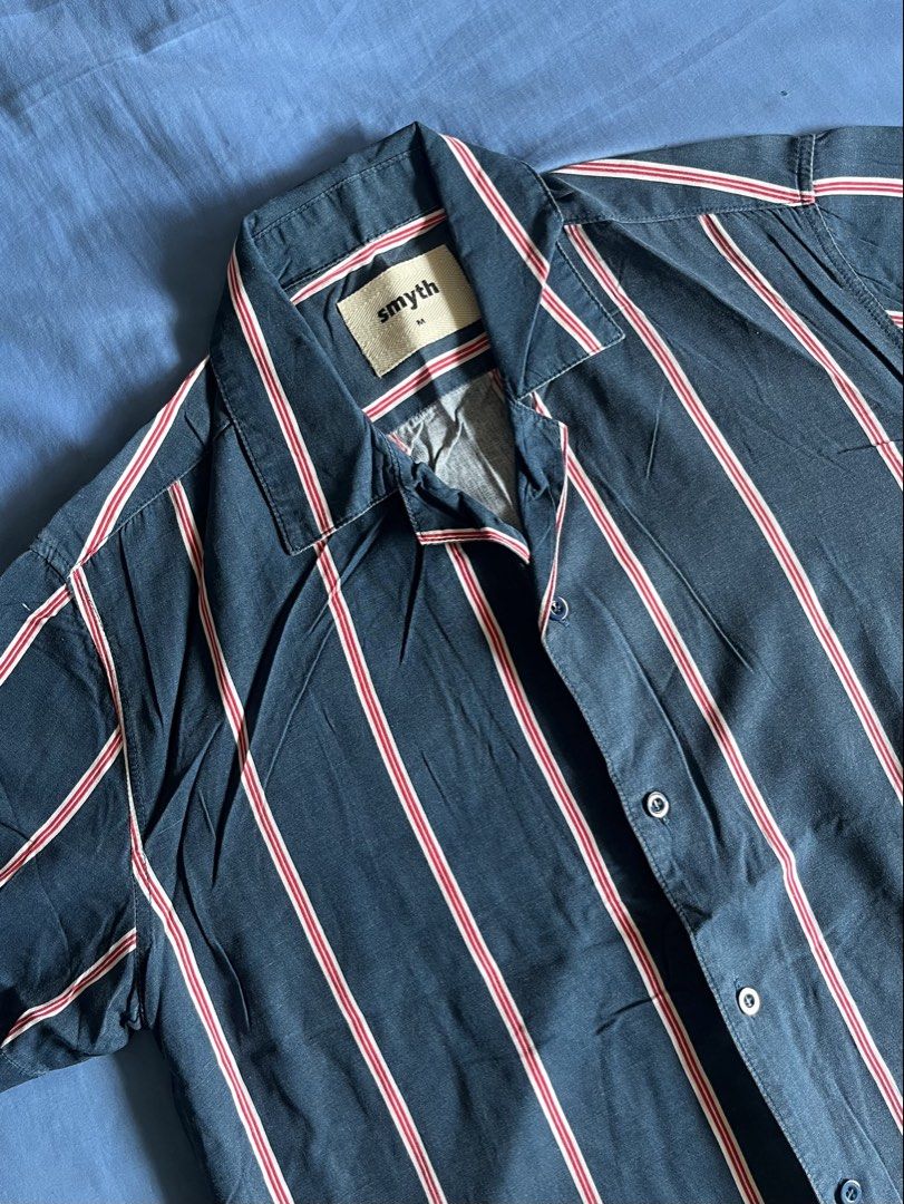 SMYTH Striped Open Collar Polo Shirt (Category: Tshirts & Polo Shirts ) located in Paranaque City. Submitted by ryanbyt (Listing ID 1442558553, Image 2). Description: SMYTH SM Youth Striped Open Collar / Camp Collar / Cuban Collar Polo Shirt - Dark blue with red and white vertical stripes - 9/10 condition Size Medium Width: 21” Length: 27” Message for inquiries.
