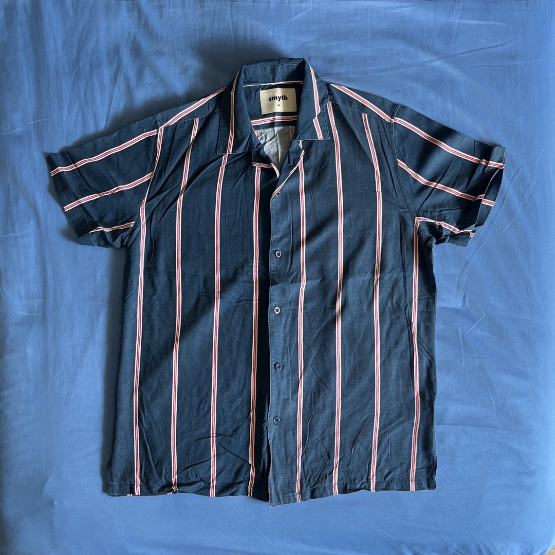 SMYTH Striped Open Collar Polo Shirt (Category: Tshirts & Polo Shirts ) located in Paranaque City. Submitted by ryanbyt (Listing ID 1442558553, Image 1). Description: SMYTH SM Youth Striped Open Collar / Camp Collar / Cuban Collar Polo Shirt - Dark blue with red and white vertical stripes - 9/10 condition Size Medium Width: 21” Length: 27” Message for inquiries.