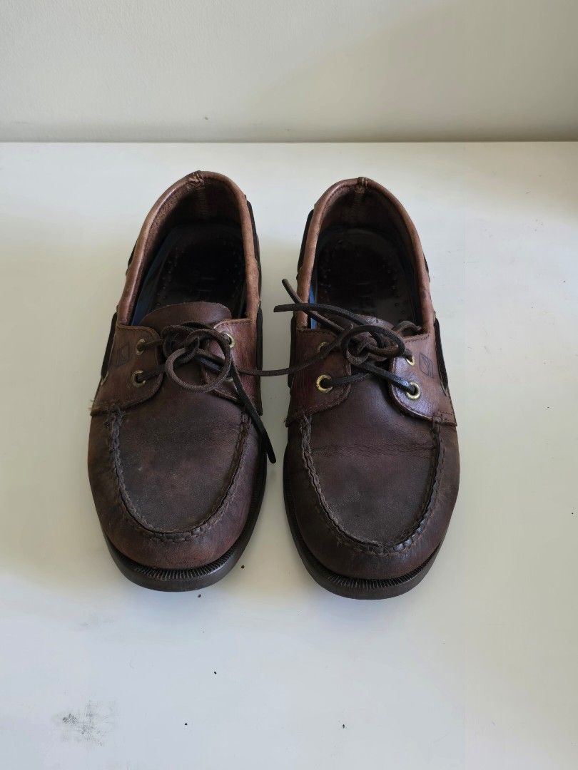 Sperry Leather Boat Shoes (Category: Dress Shoes) located in Paranaque City. Submitted by ausev (Listing ID 1442729341, Image 1). Description: Sperry Men's Leather Boat Shoes Color: Brown Size: 8.5 Material: Genuine Leather Upper Lace-Up Design Rubber Outsoles Good pre-owned condition with visible wear, scuffs, creasing, and age-related patina. Structurally sound and ready to wear. Original box not included RFS: Decluttering Price is slightly neg