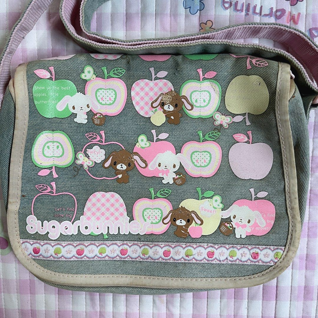 Sugarbunnies Denim Messenger Bag (Category: Shoulder Bags) located in Manila. Submitted by meeeeeraaa (Listing ID 1442723085, Image 2). Description: - Adorable denim shoulder bag -collector's piece - Stylish pink strap and trim - Secure buckle closure - Spacious interior for essentials flaw: general signs of usage, storage stains, paint faded a bit.
