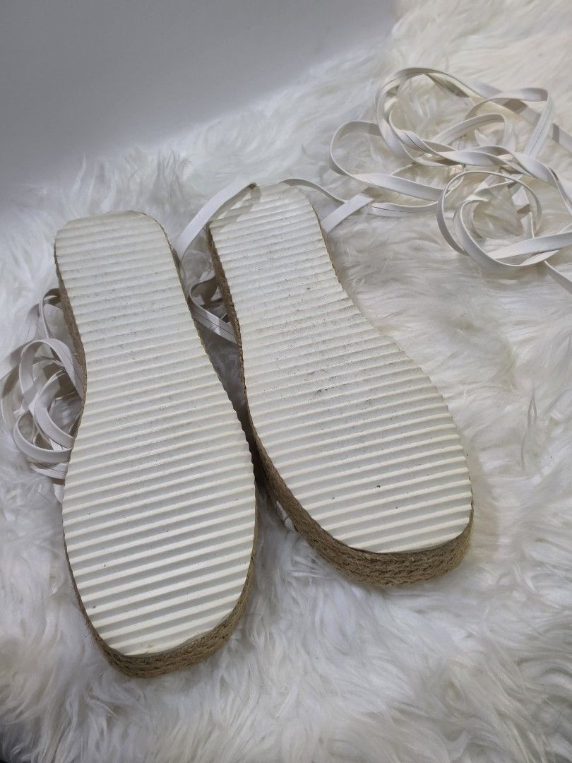 White Espadrille Platform Sandals with Tie-Up Straps (Category: Flats & Sandals) located in Mandaluyong City. Submitted by hellokrissel (Listing ID 1442708211, Image 3). Description: - Chic white espadrille platform sandals - Features a stylish braided strap across the toes - Long tie-up straps for a secure and adjustable ankle wrap - Textured sole provides excellent grip - Ideal for completing your summer outfits.