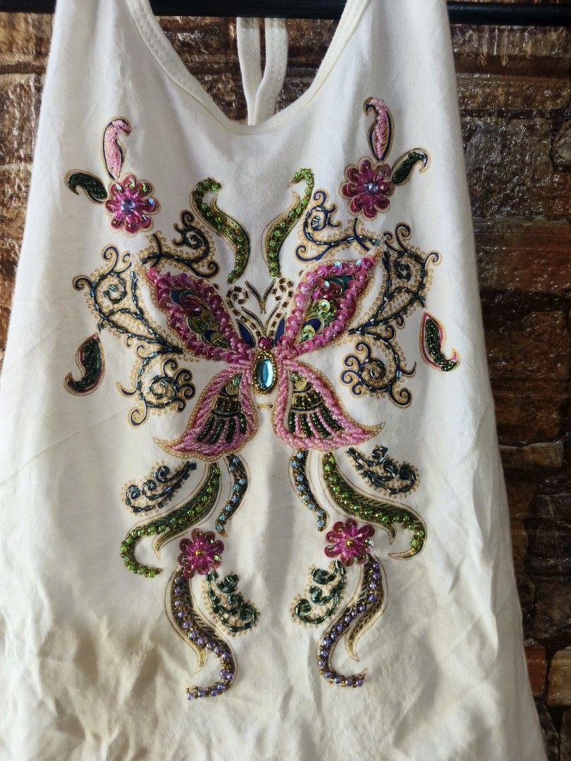 White Halter Top with Beaded Butterfly Design (Category: Sleeveless) located in Davao. Submitted by vndrgd (Listing ID 1442593352, Image 2). Description: - White halter top - Beautiful beaded butterfly design on front - 100% cotton fabric - Tag size: XS-S - Measurements: Width 12.5 inches, Length 22 inches - Origin: Made in Thailand - Ideal for casual outings or beach trips.