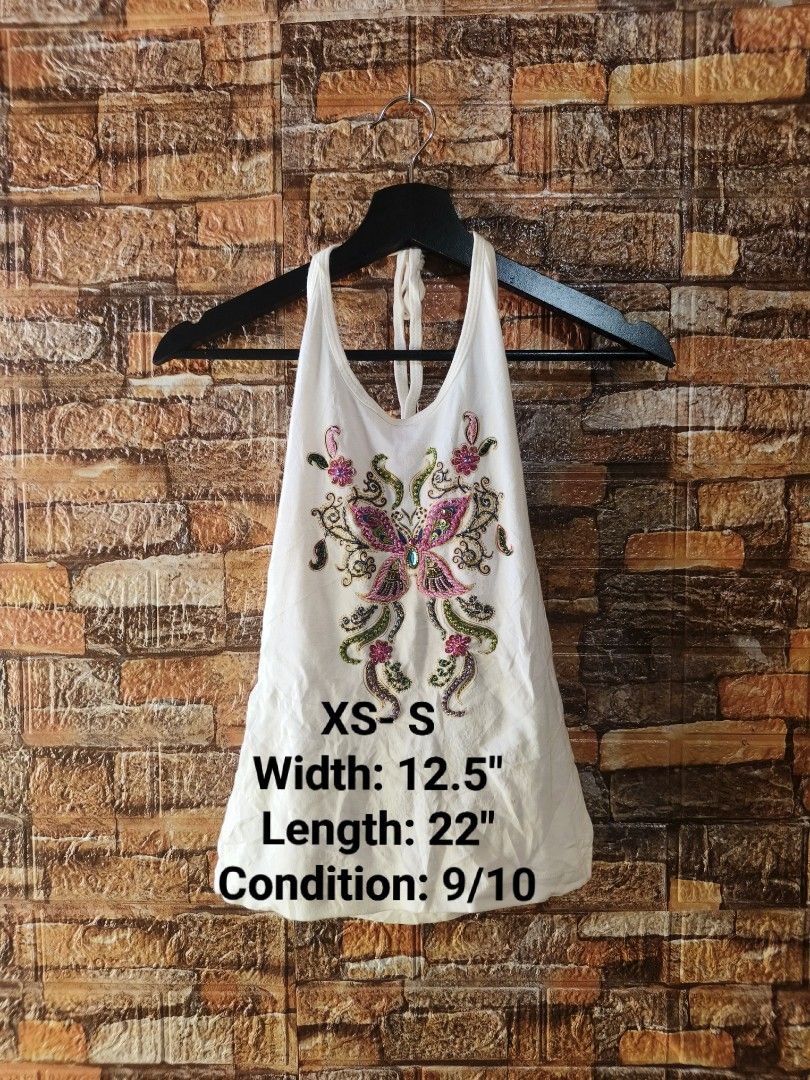 White Halter Top with Beaded Butterfly Design (Category: Sleeveless) located in Davao. Submitted by vndrgd (Listing ID 1442593352, Image 1). Description: - White halter top - Beautiful beaded butterfly design on front - 100% cotton fabric - Tag size: XS-S - Measurements: Width 12.5 inches, Length 22 inches - Origin: Made in Thailand - Ideal for casual outings or beach trips.