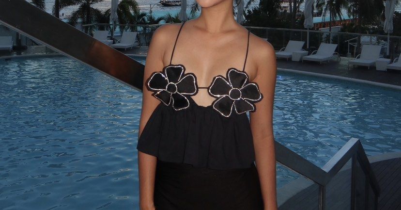 Zara Black Flower Crop Top (Category: Sleeveless) located in Cebu City. Submitted by declutter_ysh (Listing ID 1442680409, Image 2). Description: - Cute black crop top from Zara - Features two flower appliques with rhinestones on the bust - Thin spaghetti straps - Ruffled hemline - Ties at the back for adjustable fit - Ideal for parties or a night out - Size: XS.