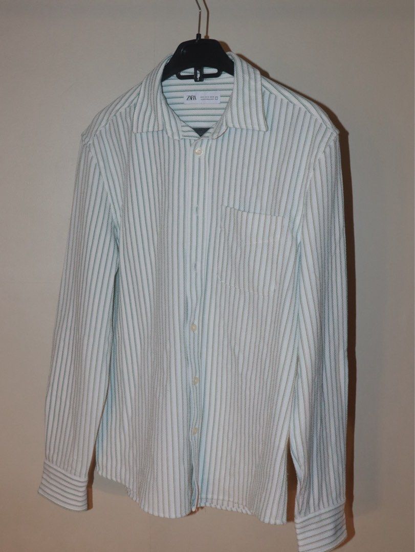 ZARA Striped Long Sleeve Shirt (Category: Tshirts & Polo Shirts ) located in Manila. Submitted by ar_archives (Listing ID 1442711305, Image 1). Description: - ZARA long sleeve shirt - Color: White with green pinstripes - Style: Button-up front with chest pocket - Size: S - Perfect for casual wear or layering - WORN ONLY ONCE .