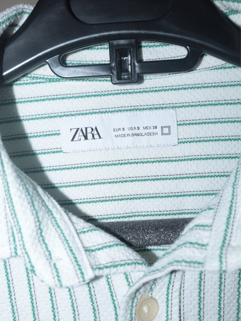 ZARA Striped Long Sleeve Shirt (Category: Tshirts & Polo Shirts ) located in Manila. Submitted by ar_archives (Listing ID 1442711305, Image 3). Description: - ZARA long sleeve shirt - Color: White with green pinstripes - Style: Button-up front with chest pocket - Size: S - Perfect for casual wear or layering - WORN ONLY ONCE .