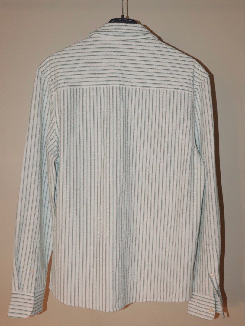 ZARA Striped Long Sleeve Shirt (Category: Tshirts & Polo Shirts ) located in Manila. Submitted by ar_archives (Listing ID 1442711305, Image 2). Description: - ZARA long sleeve shirt - Color: White with green pinstripes - Style: Button-up front with chest pocket - Size: S - Perfect for casual wear or layering - WORN ONLY ONCE .