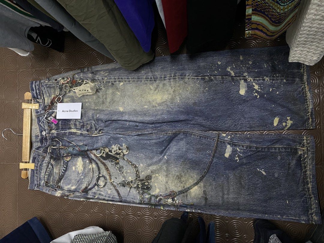Acne Studios Distressed Denim Jeans with Chains (Category: Jeans) located in Balanga. Submitted by vincentyy697259 (Listing ID 1442870733, Image 3). Description: - Acne Studios wide leg jeans - Distressed wash with paint splatters - Embellished with chains and charms - Size: EUR 32 (CN 195/92A) - Unique statement piece.