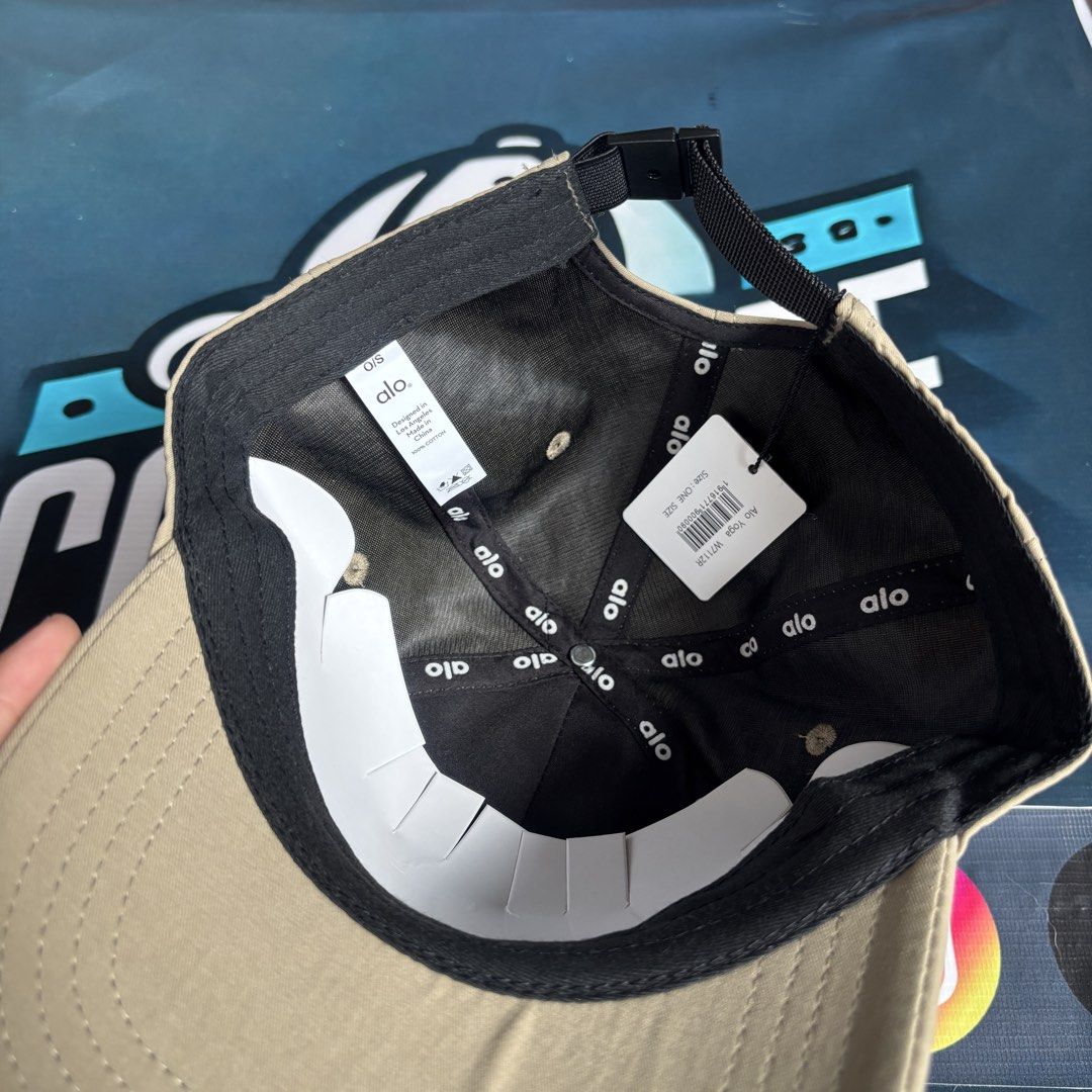 Alo Yoga Cap Tan Baseball Hat (Category: Caps & Hats) located in Balagtas. Submitted by capspree (Listing ID 1442802931, Image 3). Description: - Brand: Alo Yoga - Color: Tan - Style: Classic baseball cap - Features: Adjustable strap at the back for a custom fit - Design: Simple Alo Yoga logo on the front - Ideal for: Everyday wear, casual outings, sports activities.