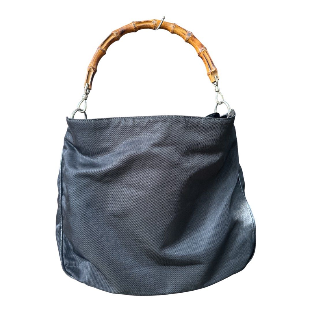 Authentic Gucci Vintage Nylon Top Handle Bag (Category: Luxury Bags & Wallets) located in Santa Rosa. Submitted by Minerva_Shelter (Listing ID 1442834226, Image 1). Description: Authentic Gucci Vintage Nylon Top Handle Bag Measurements: (manually measured when laid flat) Height: 13 in. Depth: 4 in. Width: 16 in. Drop: 7 in. Material: classic durable, black nylon with leather accents, finished with Gucci’s signature bamboo handle Design: - Designe