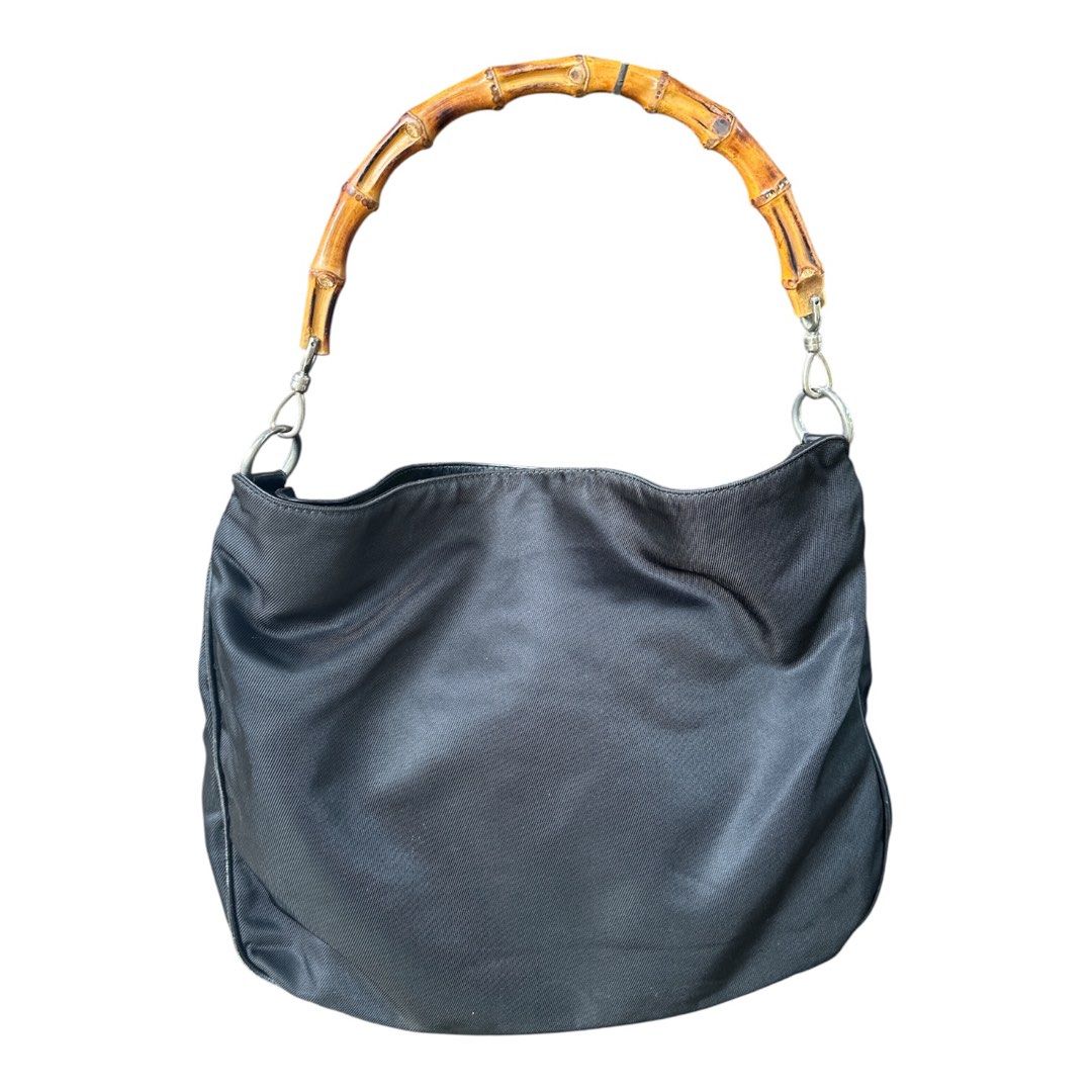 Authentic Gucci Vintage Nylon Top Handle Bag (Category: Luxury Bags & Wallets) located in Santa Rosa. Submitted by Minerva_Shelter (Listing ID 1442834226, Image 3). Description: Authentic Gucci Vintage Nylon Top Handle Bag Measurements: (manually measured when laid flat) Height: 13 in. Depth: 4 in. Width: 16 in. Drop: 7 in. Material: classic durable, black nylon with leather accents, finished with Gucci’s signature bamboo handle Design: - Designe
